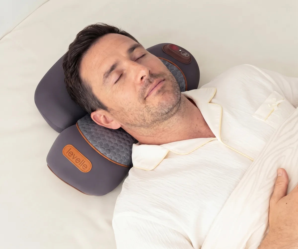 A woman lying back on the RestWell Pillow with her eyes closed