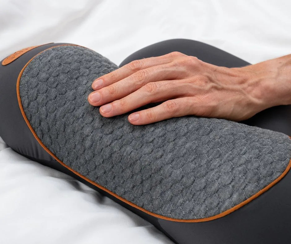A hand pressing into the RestWell Pillow's quilted cover